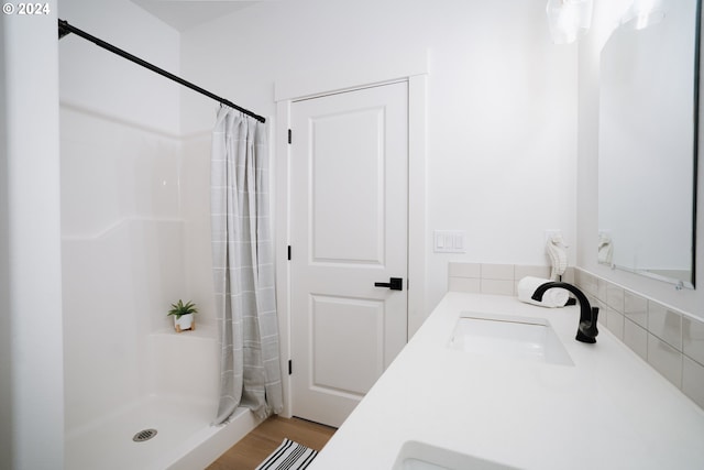 bathroom with curtained shower and vanity