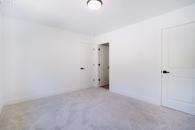 unfurnished bedroom with carpet and baseboards