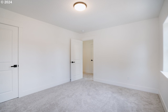 empty room featuring light carpet