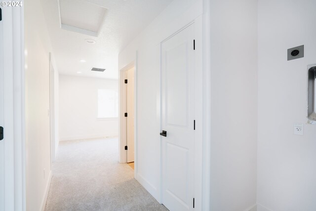 corridor with light colored carpet