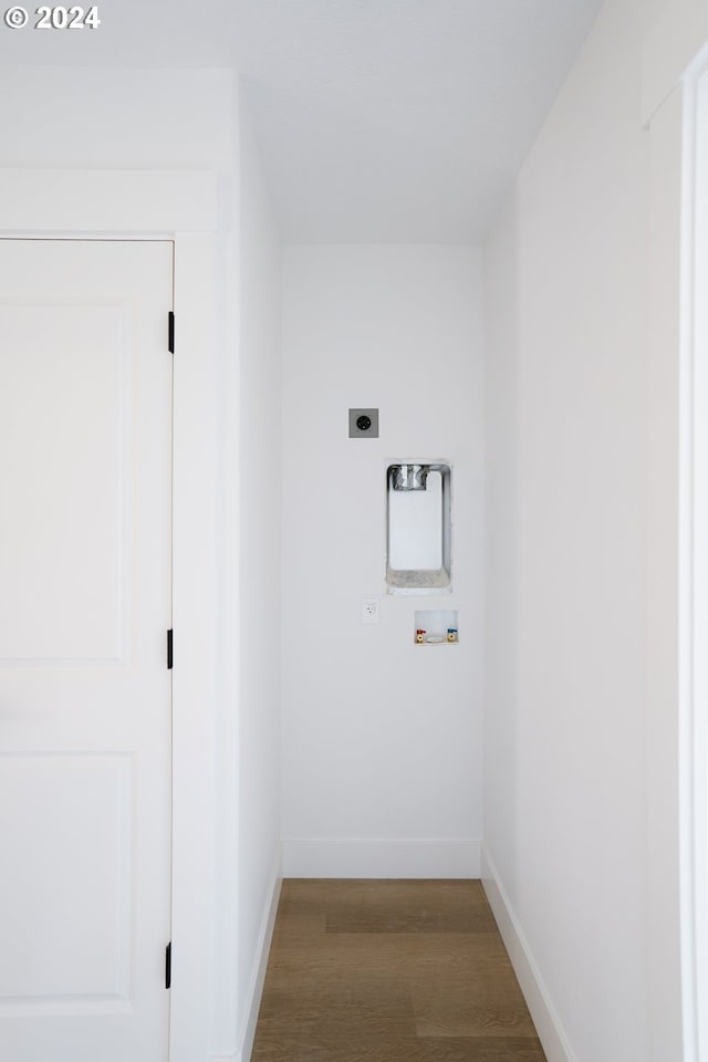 washroom featuring hookup for an electric dryer, wood-type flooring, and washer hookup