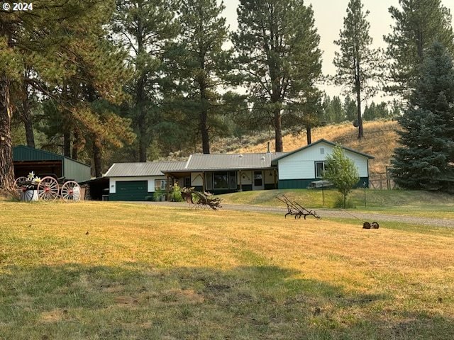 view of front of house with a garage and a front yard