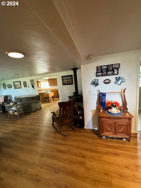 dining room with hardwood / wood-style floors and a textured ceiling