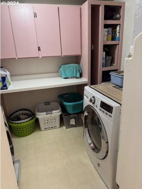 laundry area featuring cabinets and washer / clothes dryer