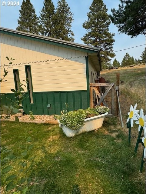 view of side of home featuring a lawn