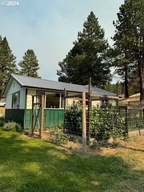 view of outbuilding featuring a lawn