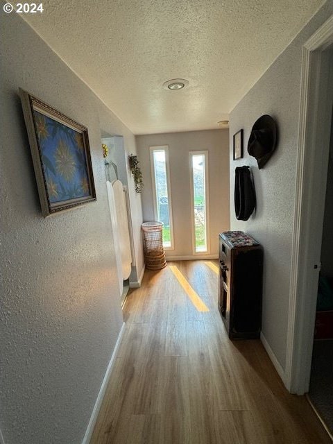 corridor featuring hardwood / wood-style floors and a textured ceiling