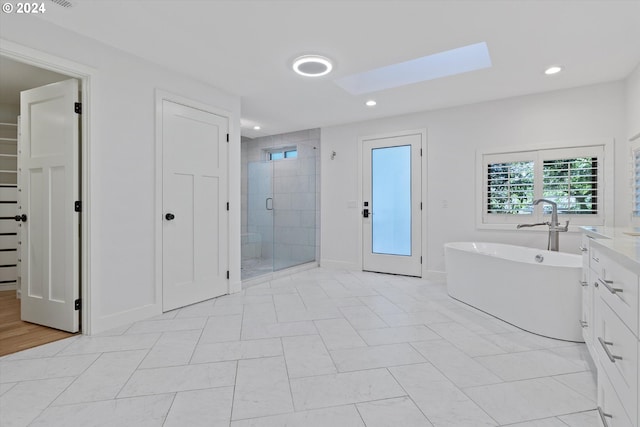 bathroom featuring vanity and separate shower and tub