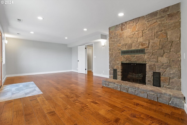 unfurnished living room with a fireplace and wood-type flooring