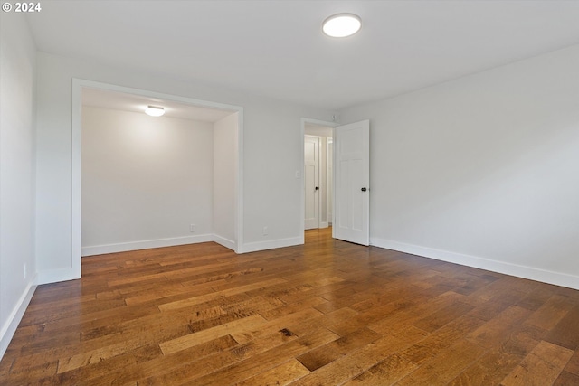 empty room with hardwood / wood-style floors