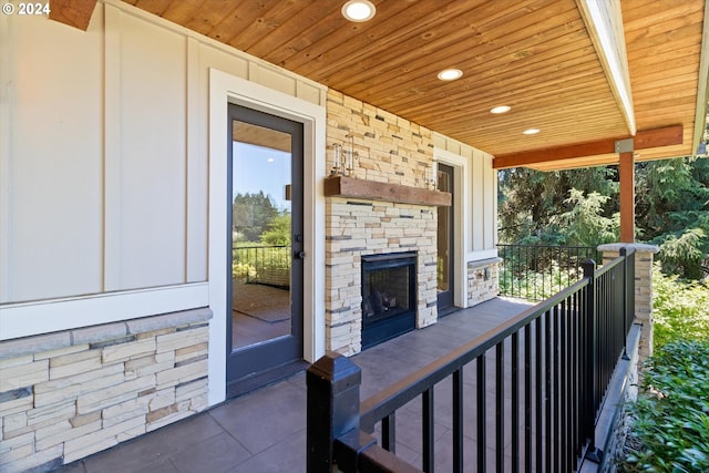 view of patio / terrace with covered porch and an outdoor stone fireplace