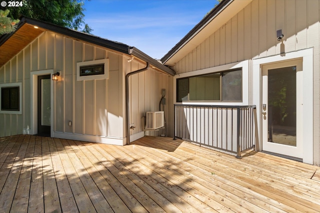 wooden deck with an AC wall unit