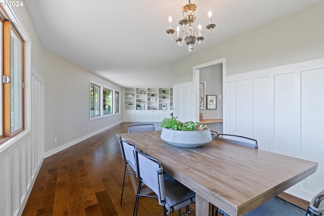 dining area featuring dark hardwood / wood-style flooring and an inviting chandelier