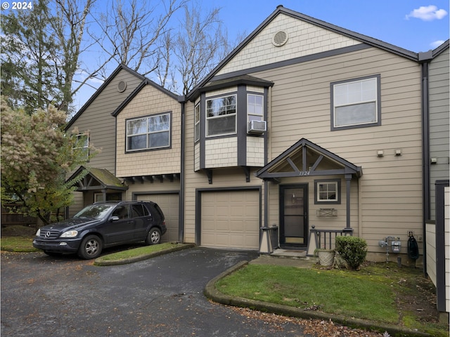 view of front of property with a garage and cooling unit