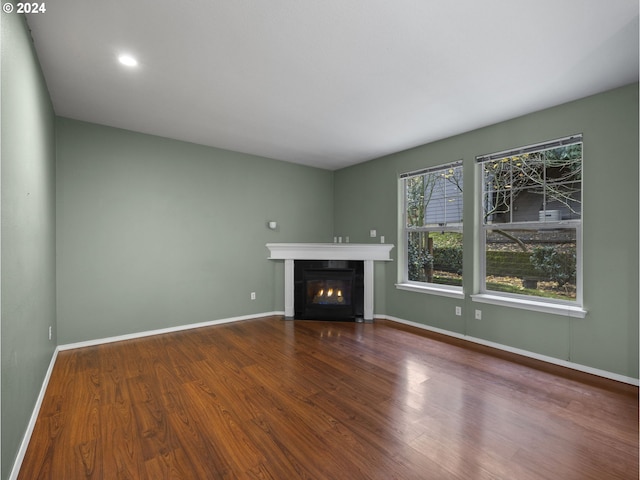 unfurnished living room featuring hardwood / wood-style flooring