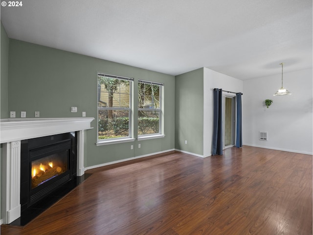 unfurnished living room featuring dark wood-type flooring