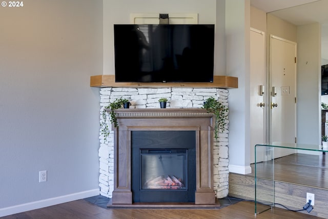 room details with hardwood / wood-style flooring and a fireplace