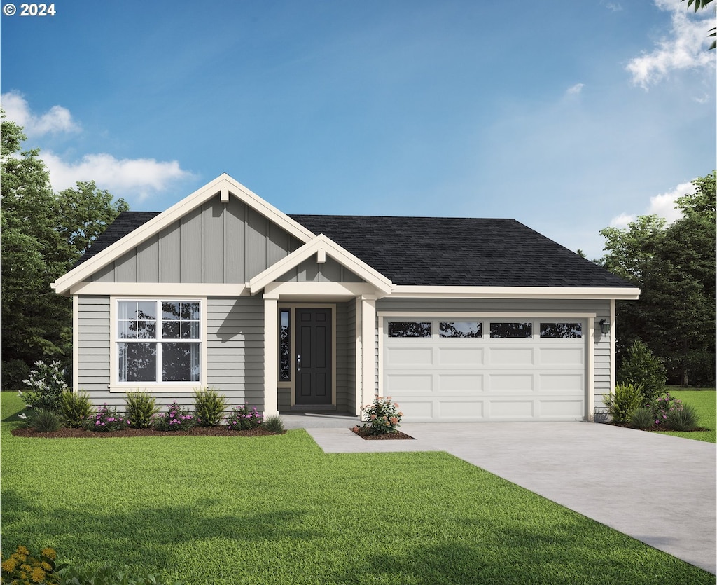 view of front of house with a front lawn and a garage