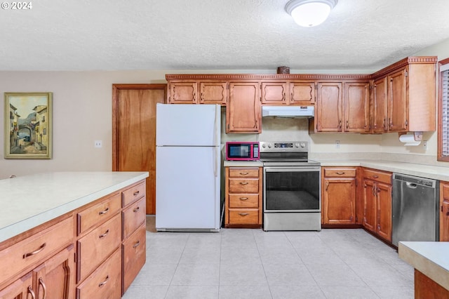 kitchen featuring a textured ceiling, appliances with stainless steel finishes, and light tile patterned floors