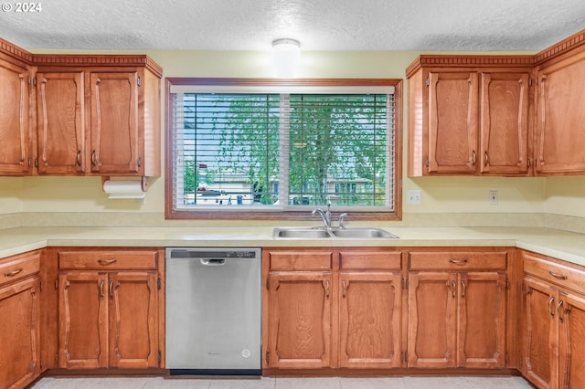 kitchen with a textured ceiling, dishwasher, sink, and plenty of natural light