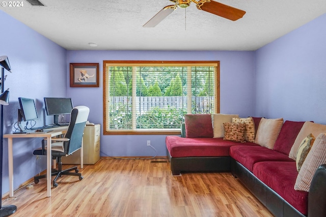 office space with light hardwood / wood-style flooring, ceiling fan, and a textured ceiling