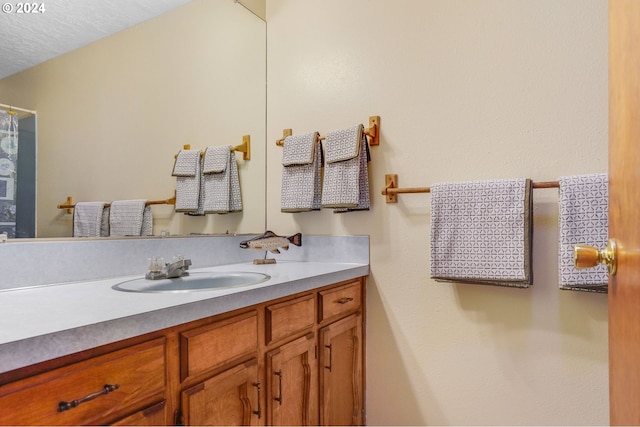 bathroom with vanity and a textured ceiling