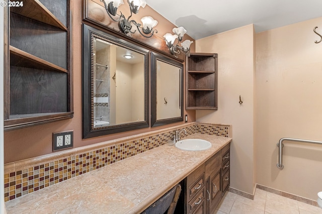 bathroom with vanity, toilet, backsplash, and tile patterned flooring