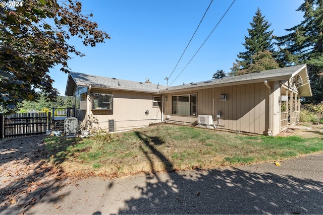 rear view of property featuring ac unit