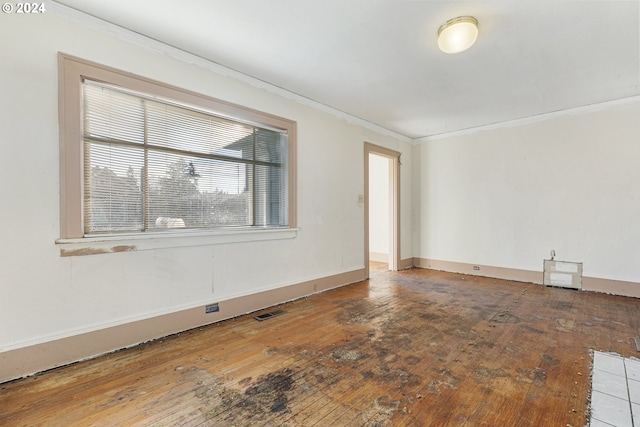 unfurnished room featuring crown molding and wood-type flooring