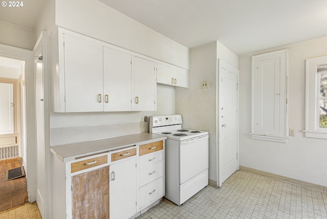 kitchen featuring white cabinetry, white electric stove, and light hardwood / wood-style flooring