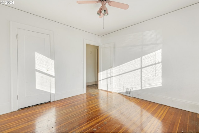 empty room with ceiling fan and wood-type flooring