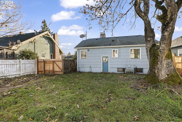 back of house with a lawn