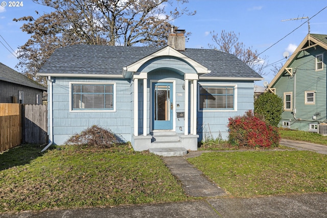 bungalow-style house with a front lawn