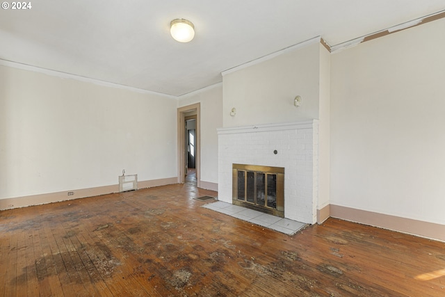 unfurnished living room with a fireplace, hardwood / wood-style floors, and ornamental molding