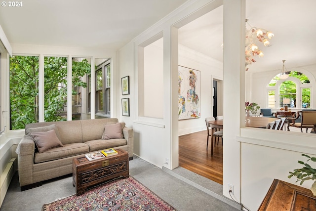 sunroom / solarium with a chandelier and a baseboard radiator