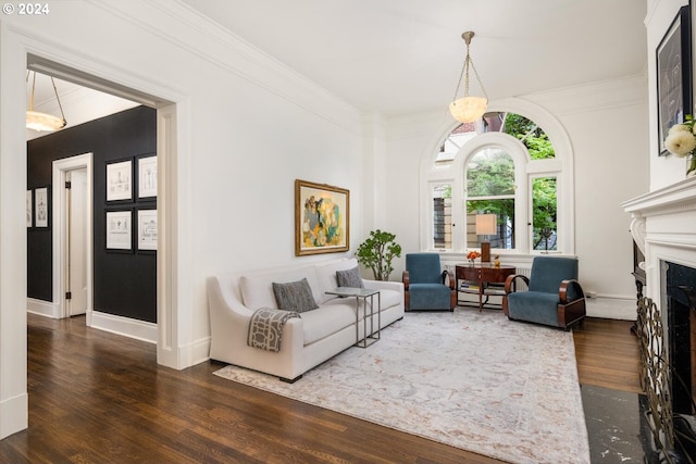 living room with dark hardwood / wood-style floors and crown molding