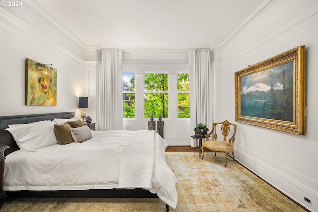 bedroom with wood-type flooring and crown molding