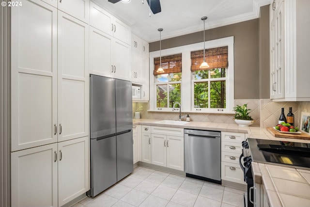 kitchen featuring white cabinets, ceiling fan, stainless steel appliances, and sink