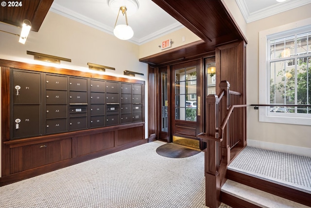 entrance foyer featuring crown molding and a mail area