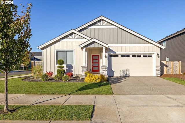 view of front of house featuring a garage and a front yard