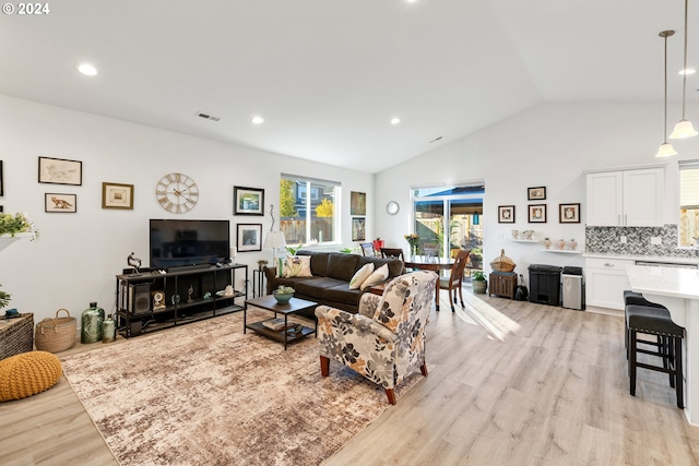 living room featuring light hardwood / wood-style floors and vaulted ceiling