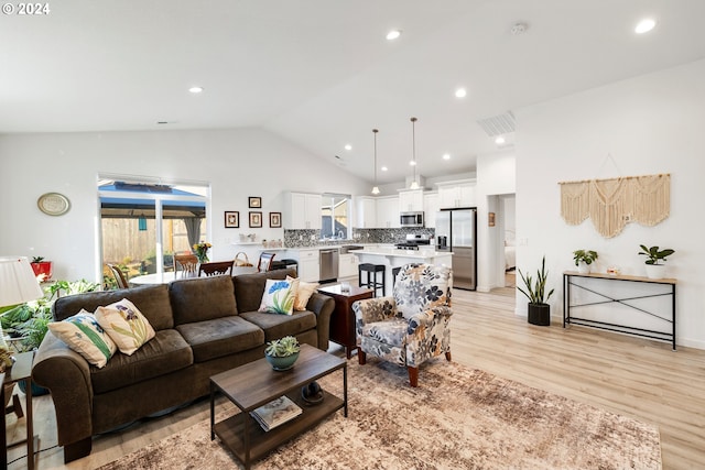 living room featuring light hardwood / wood-style floors and lofted ceiling