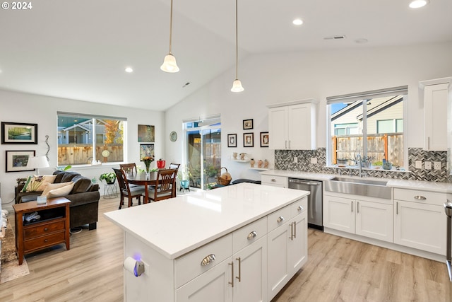 kitchen with dishwasher, light wood-type flooring, white cabinets, and pendant lighting