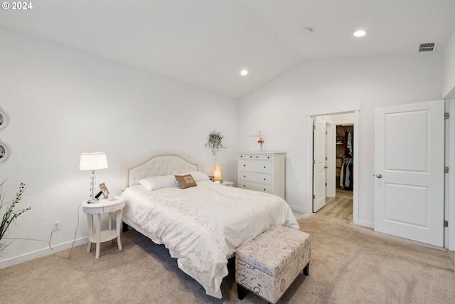 carpeted bedroom with vaulted ceiling