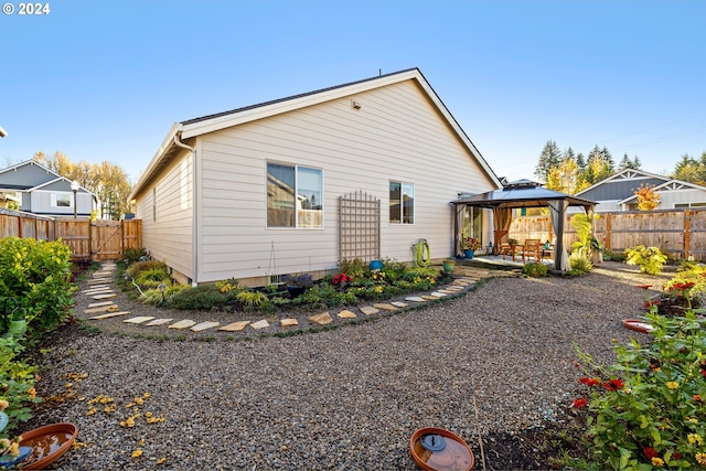 rear view of property with a patio area and a gazebo