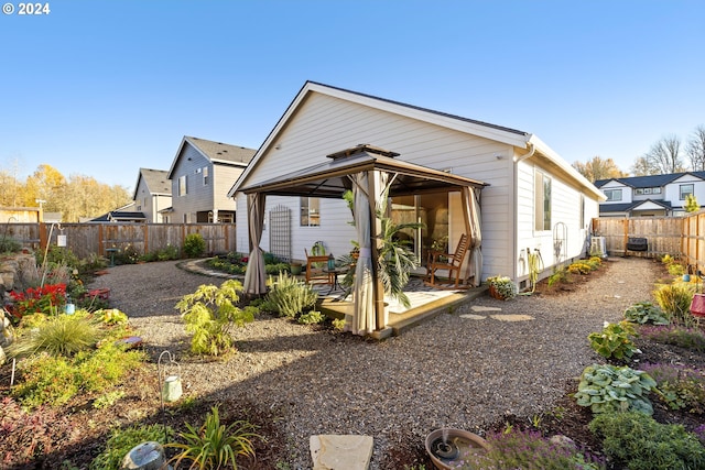 rear view of property featuring a gazebo