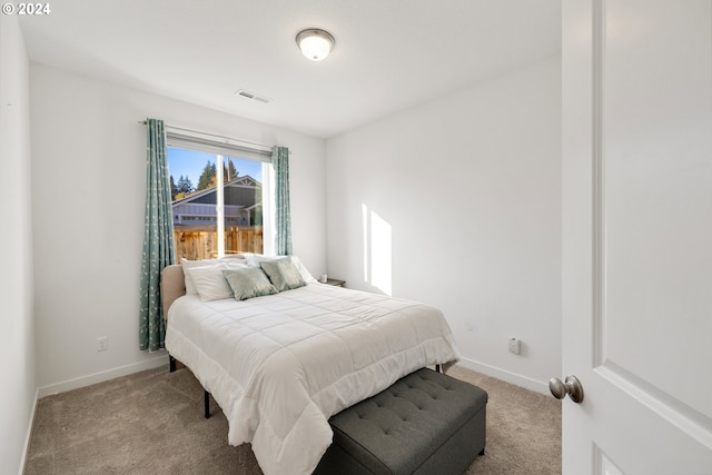 bedroom with light colored carpet