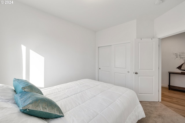 bedroom with hardwood / wood-style floors and a closet