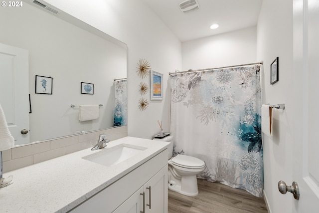 bathroom with hardwood / wood-style floors, vanity, toilet, and a shower with shower curtain