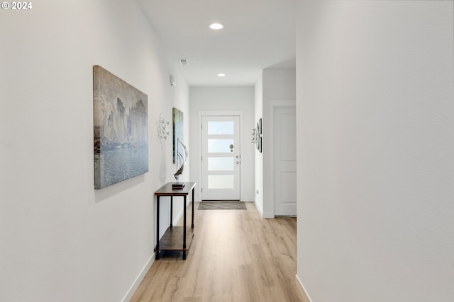 corridor with light hardwood / wood-style flooring